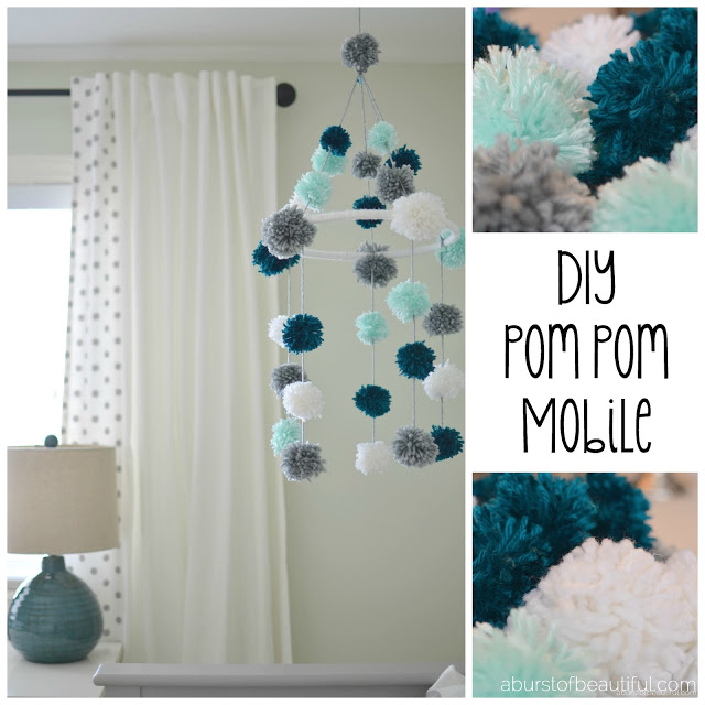A DIY pom-pom mobile made from yarn and an embroidery hoop is a fun and stimulating addition to your little one's nursery. Find the full tutorial at www.aburstofbeautiful.com | A Burst of Beautiful 